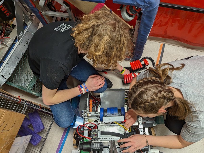 Conifer robotics team members Rhys Hanson, left, and Hannah Stauffer find parts to use to create a new robot.